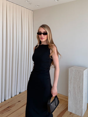 Siyah drapeli polyester midi elbisenin bel ve gövde detayı önden çekim